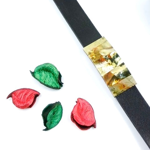 Artisan leather bracelet detail showing distinctive weave pattern with green and white amber embellishments