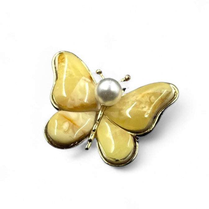 A Brooch in the Shape of a Butterfly with Yellow Wings and a Central Pearl Embellishment