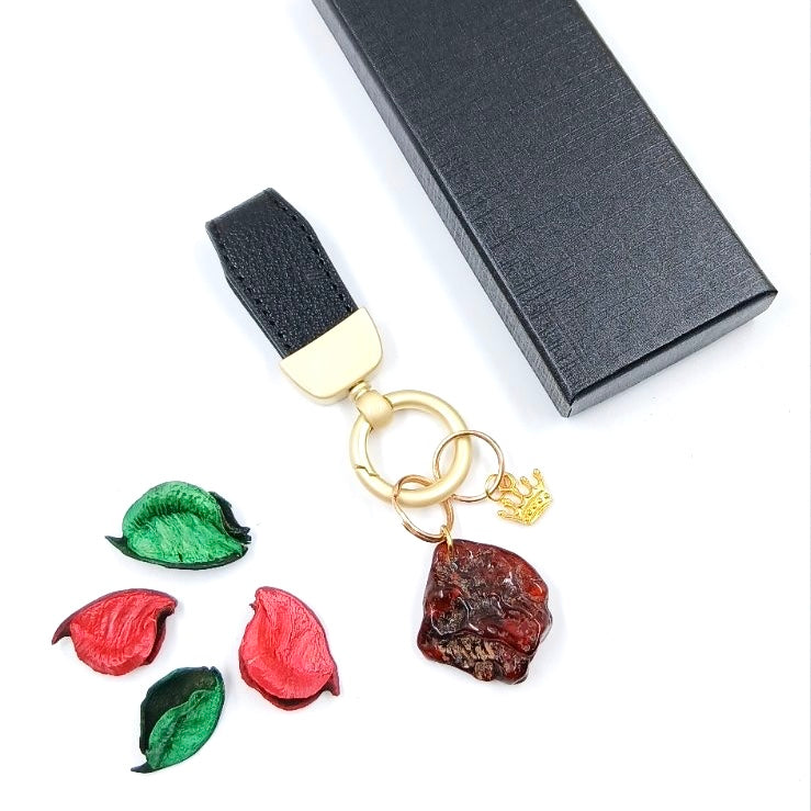 Dark Baltic amber keychain with leather cord - rich cognac tones and natural patterns