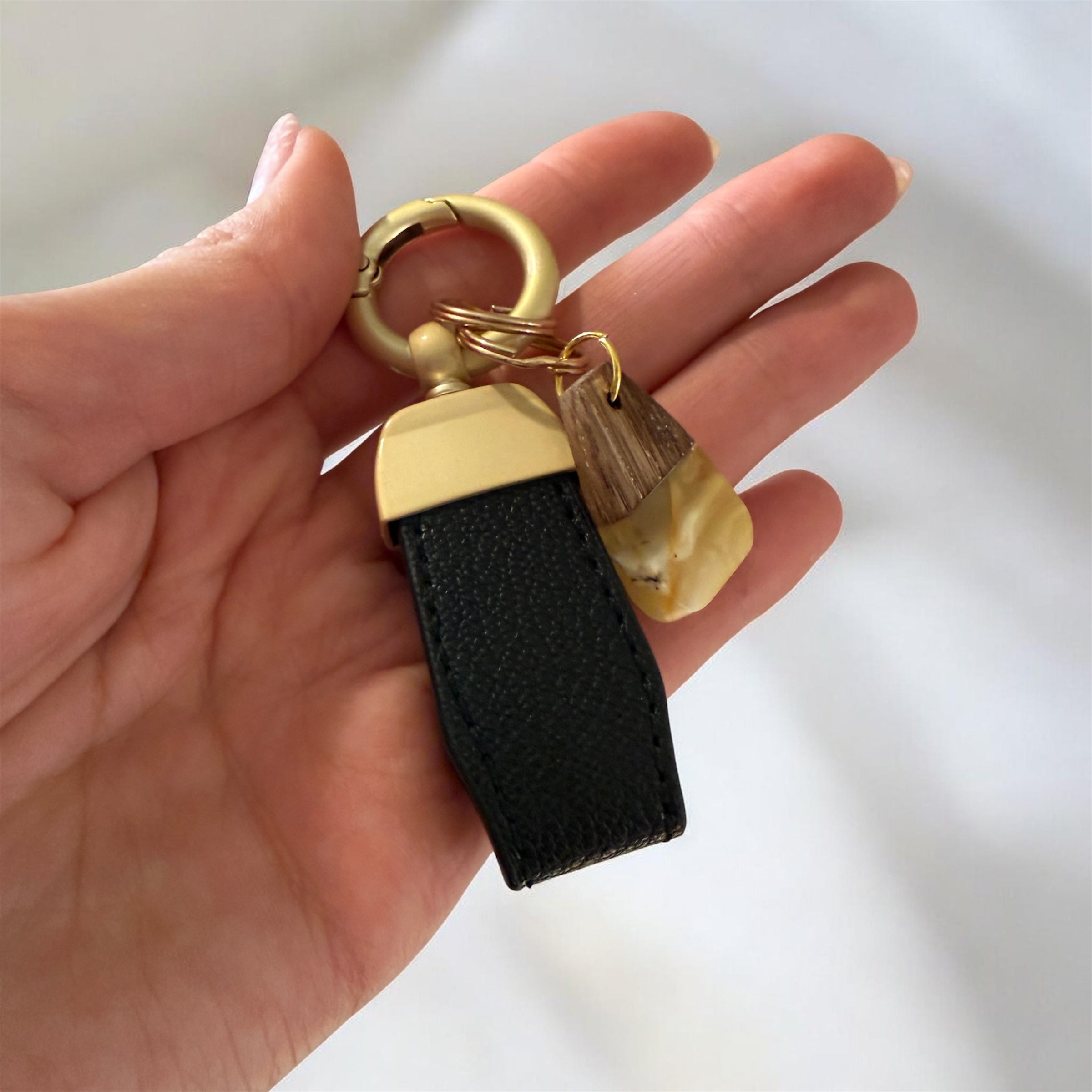 Elegant keychain made of Baltic amber, wood, and eco leather strap