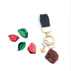 Handcrafted black-brown amber keychain on leather strap with metal keyring