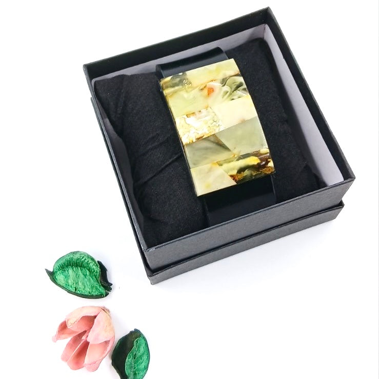 Handcrafted brown leather cuff bracelet featuring honey-colored Baltic amber accents