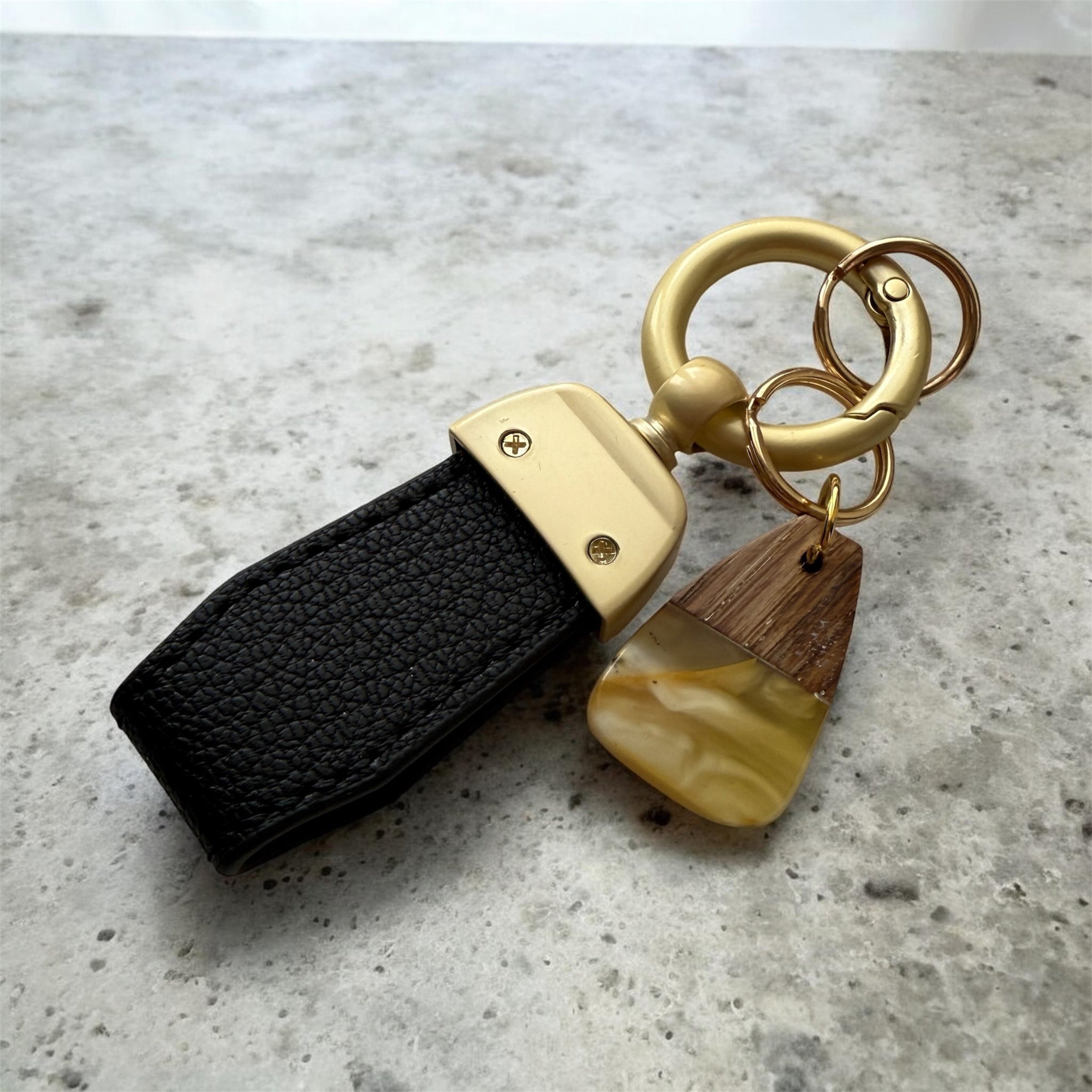 Minimalist amber keychain accessory with gold ring and black loop