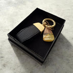 Natural Baltic amber keychain with wooden accent and black strap