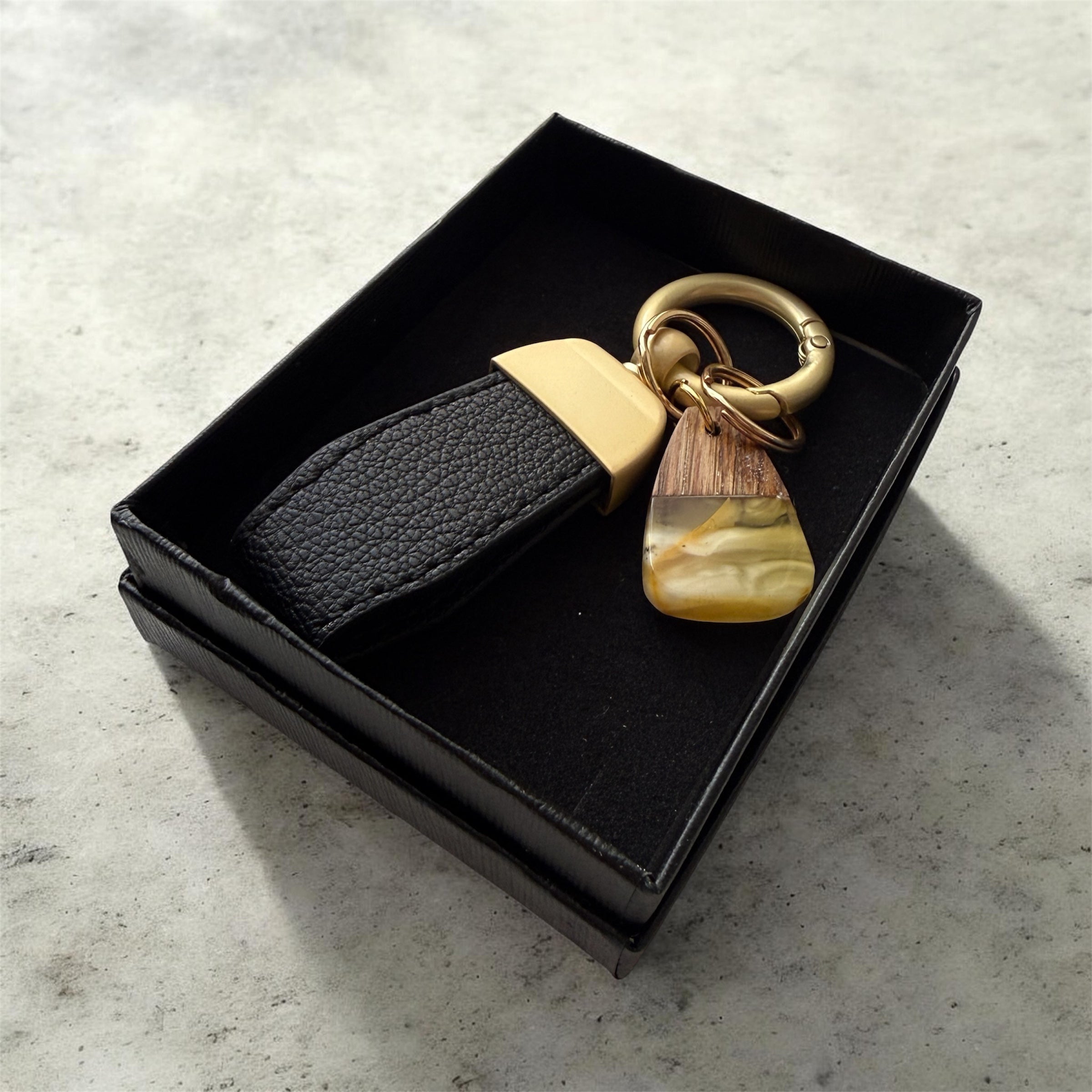 Natural Baltic amber keychain with wooden accent and black strap
