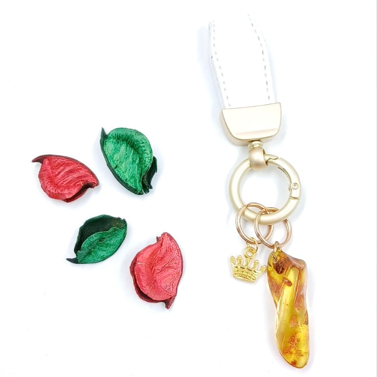 White Baltic amber keychain with brown leather cord and metal ring