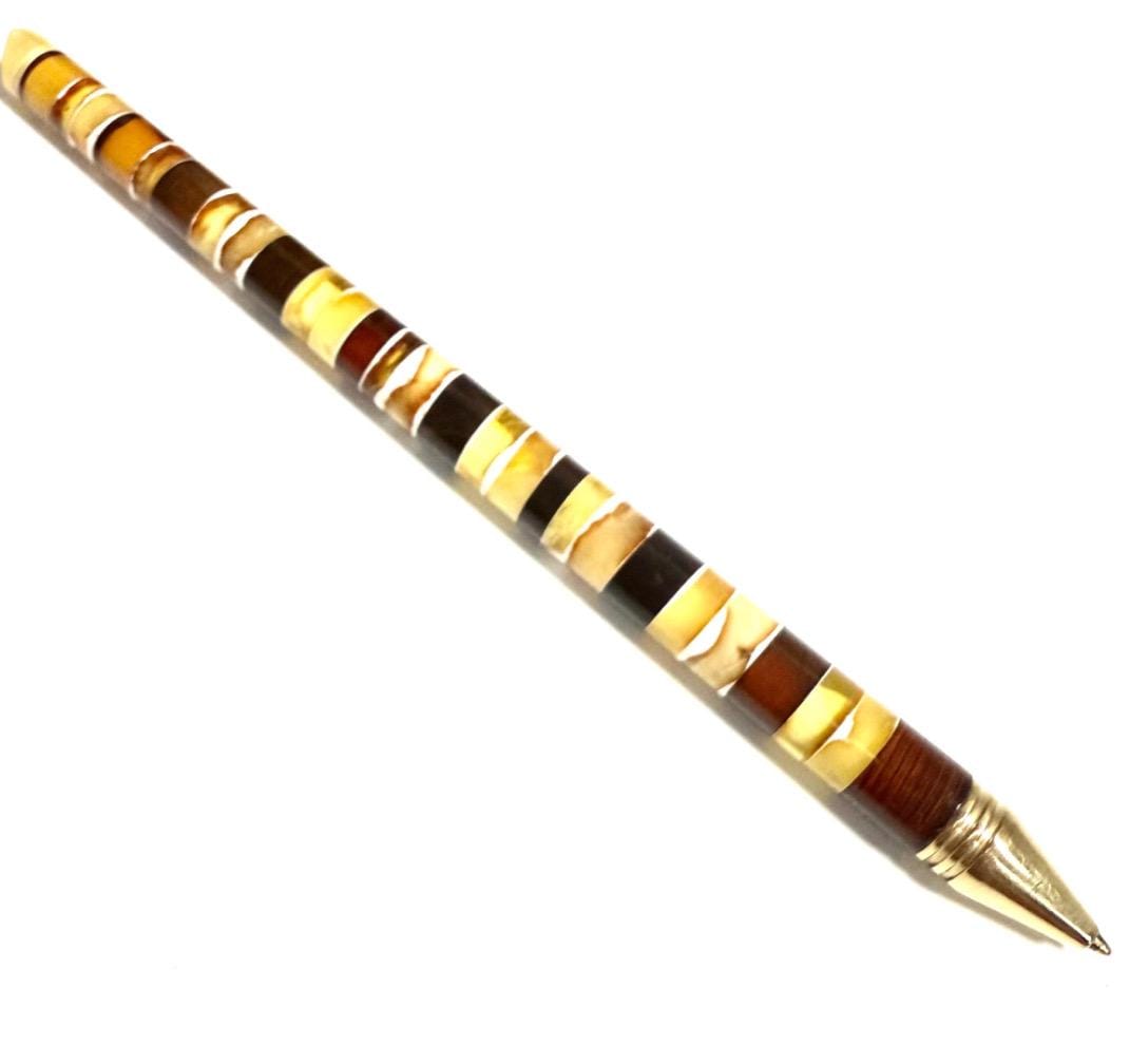 Elegant wood and metal ballpoint pen featuring natural Baltic amber accents