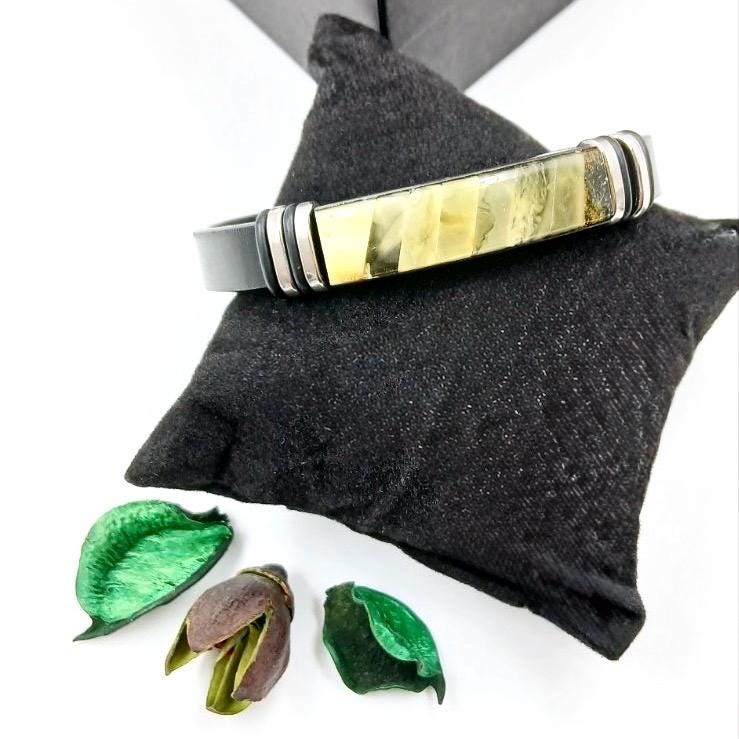 Modern slim leather wristband featuring stainless steel details with green amber