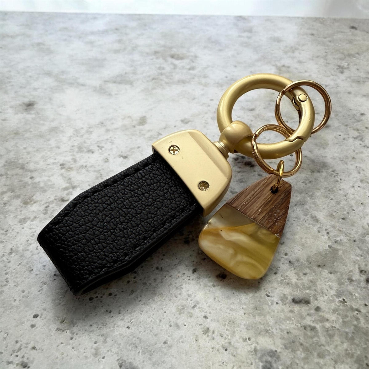 Elegant keychain made of Baltic amber, wood, and eco leather strap