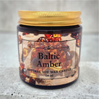 Natural soy wax candle with Baltic Amber fragrance, decorated with genuine Baltic amber stones in an elegant amber glass container.
