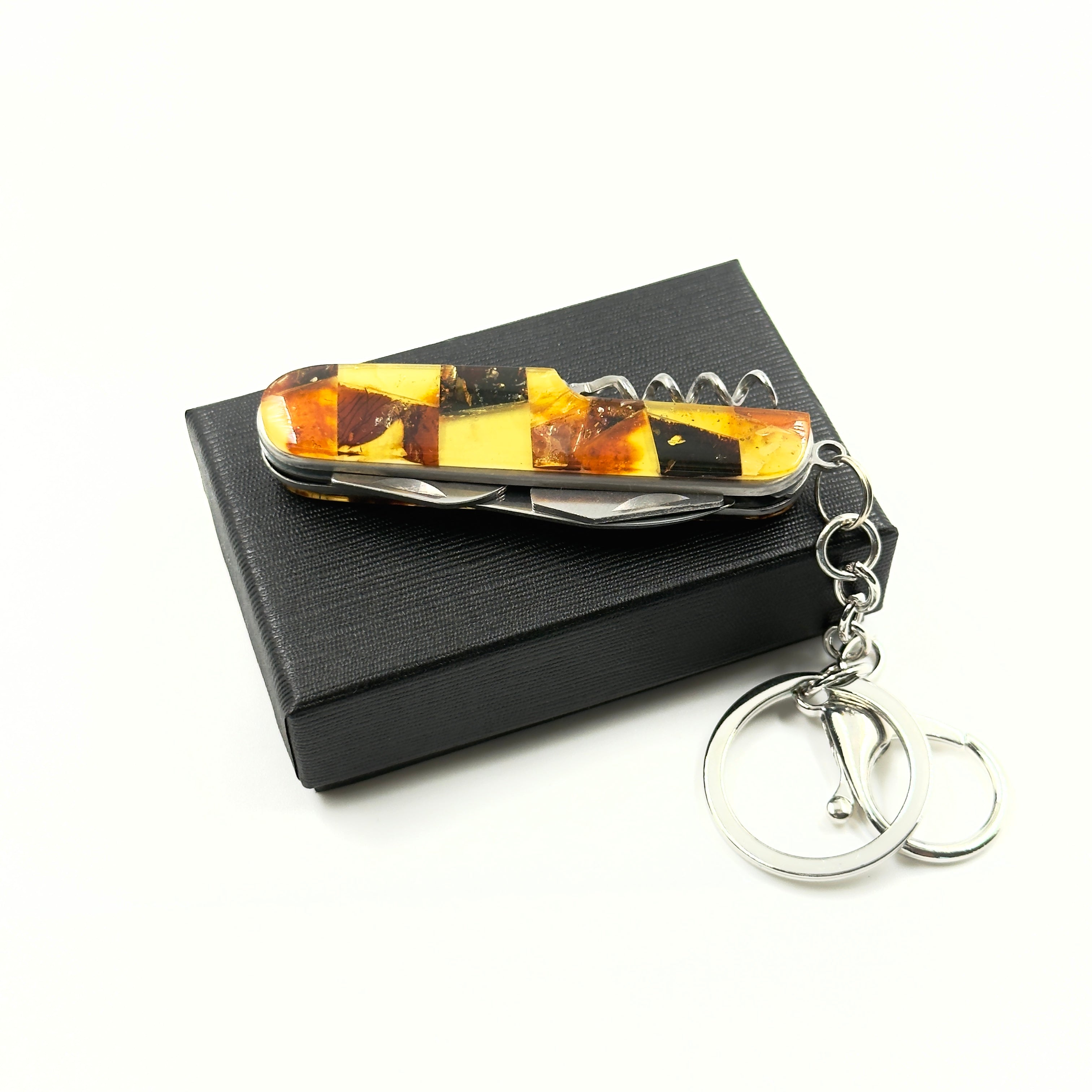  multi-functional pocket knife with amber inlay showing folded compact design